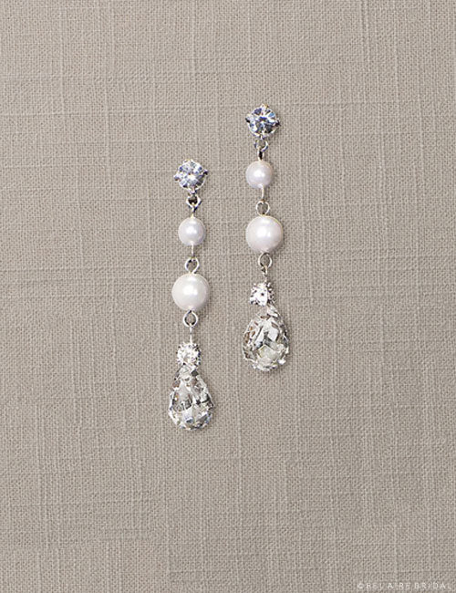 Pearl drop crystal earrings Lustrous, hanging double pearl drops and pear-cut rhinestones glimmer with delicate, glamorous detail! Perfect as a light embellishment for a wedding in any season.